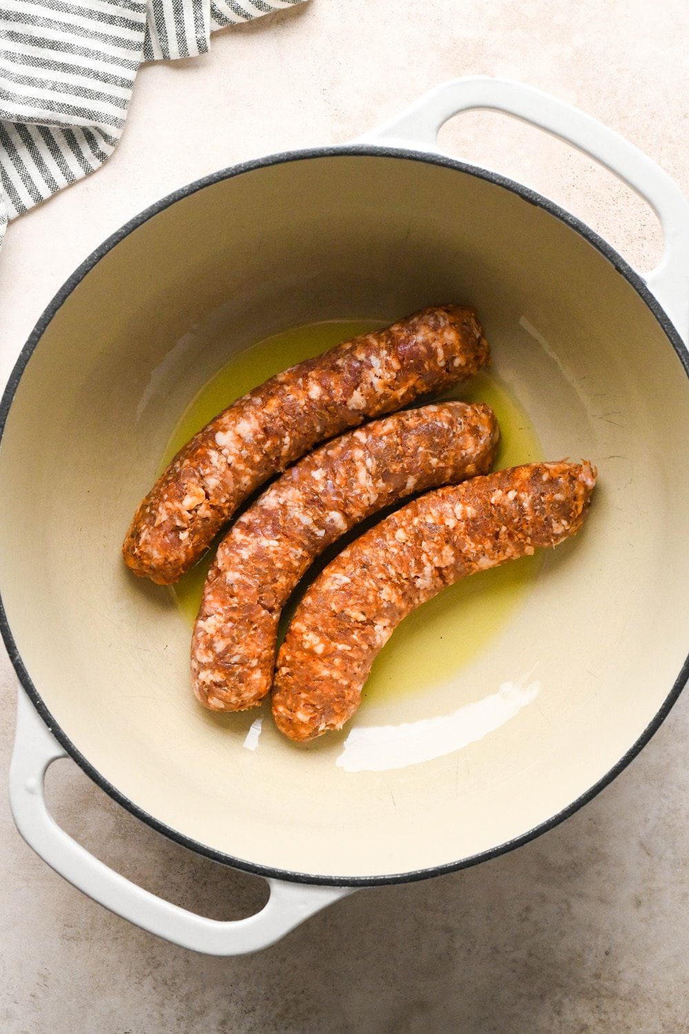 How to make Brothy Sausage and Potato Soup with Kale and Cabbage: Raw sausages in soup pot before cooking