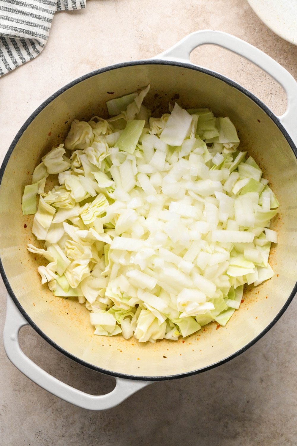 How to make Brothy Sausage and Potato Soup with Kale and Cabbage: Cabbage and onions in the pot before cooking.