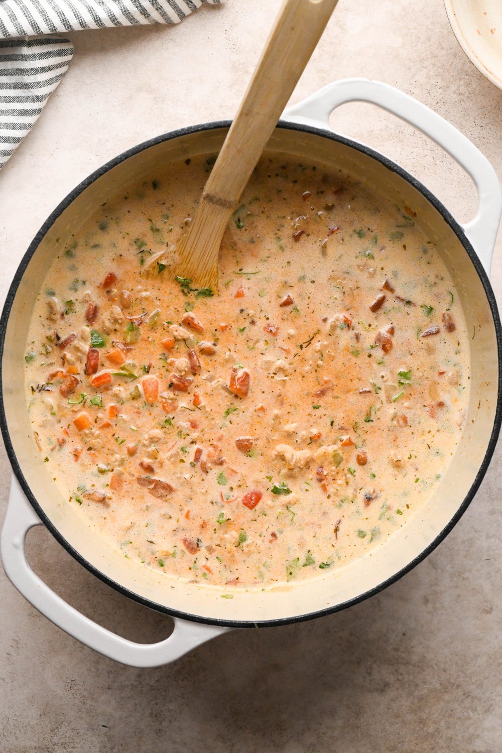 How to make Cashew Cream Buffalo Chicken Chili Made with Ground Chicken: Cashew cream in the pot of soup with drained beans and chopped cilantro stirred into the soup, before simmering to thicken.