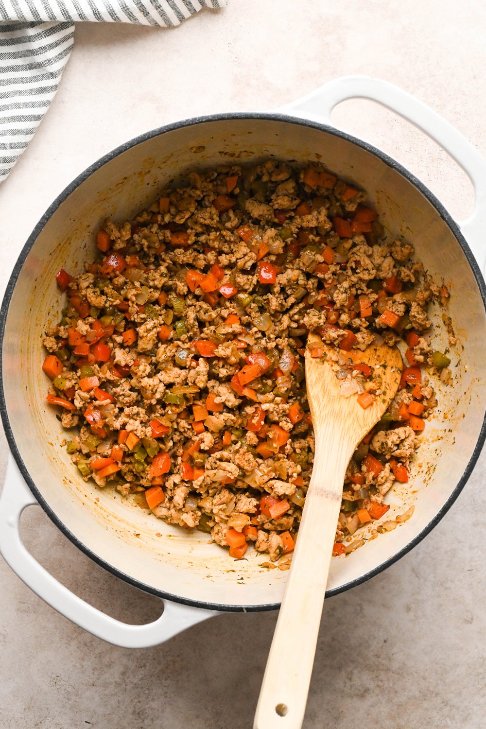 How to make Cashew Cream Buffalo Chicken Chili Made with Ground Chicken: Dried spices added to the pot with the chicken and vegetables and stirred to combine.