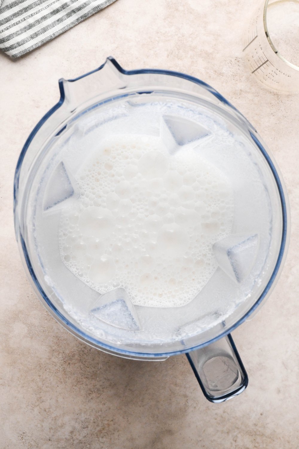 How to make Gluten Free Sausage Gravy: Blender container with soaked and drained raw cashews with chicken broth after blending into cashew cream mixture.