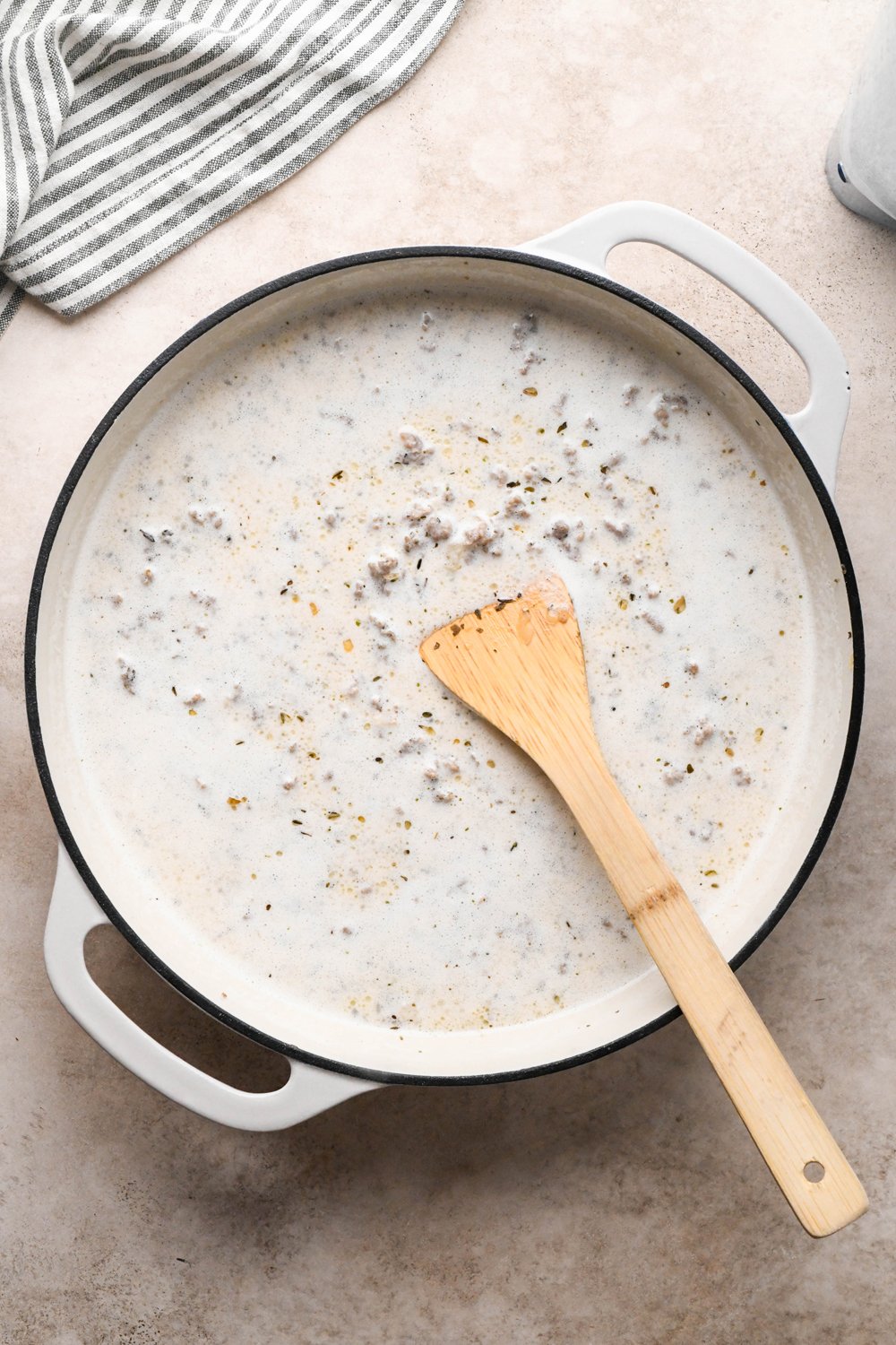 How to make Gluten Free Sausage Gravy: Cashew cream mixture in the skillet with cook sausage before simmering to thicken.