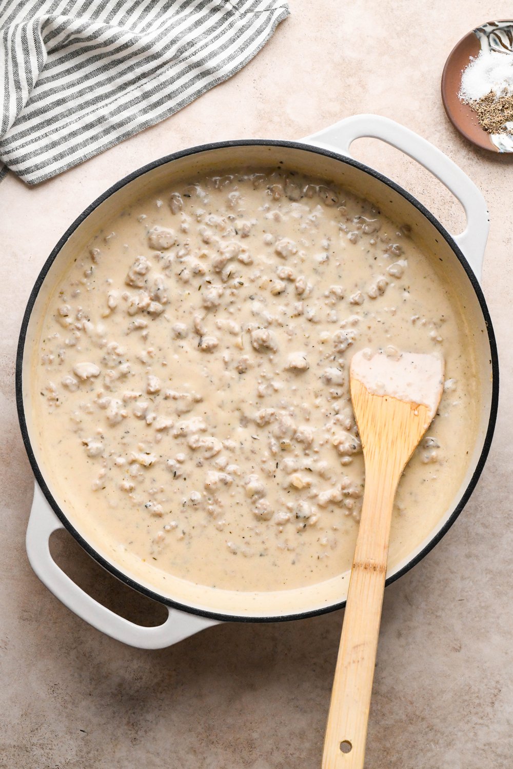 How to make Gluten Free Sausage Gravy: Cashew cream mixture in the skillet with cook sausage after simmering to thicken.