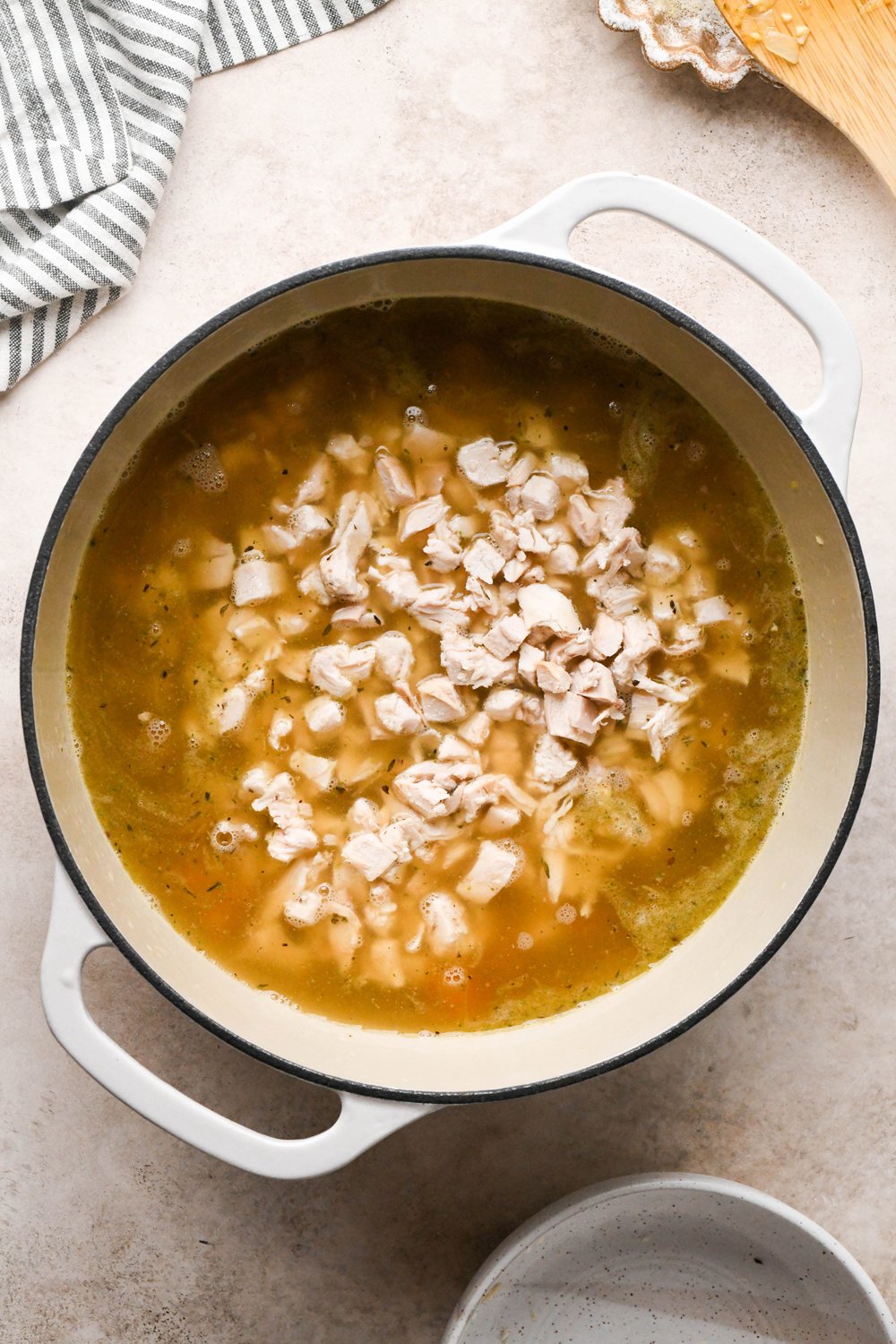 How to make Chicken and Broccoli Soup: Chicken broth and shredded chicken added to the soup pot.