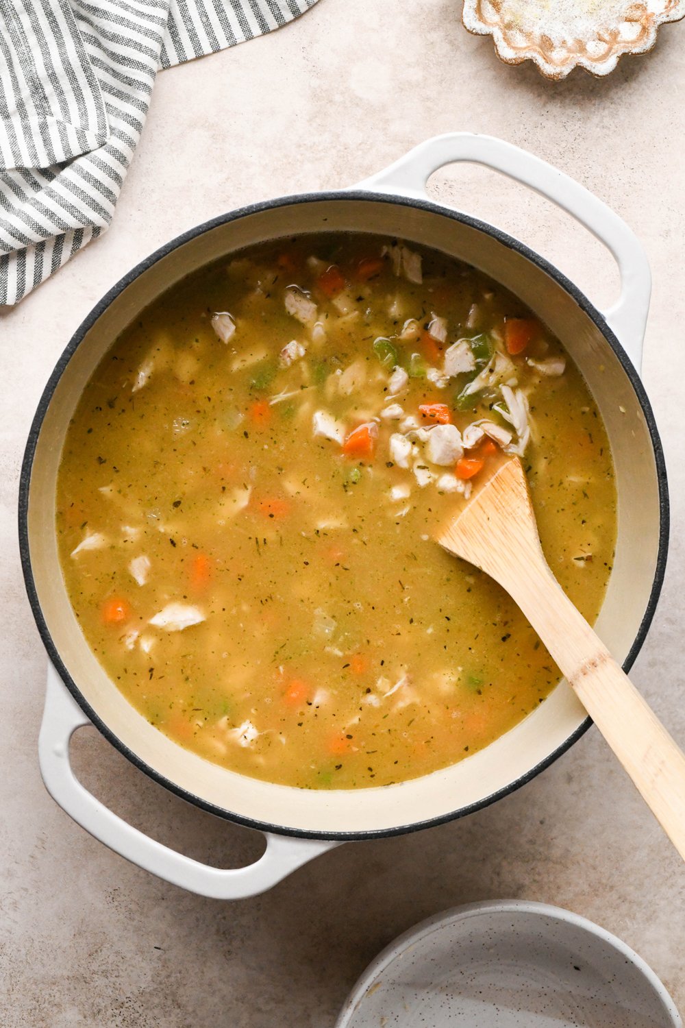 How to make Chicken and Broccoli Soup: Soup stirred together with broth and chicken, before continuing to simmer.
