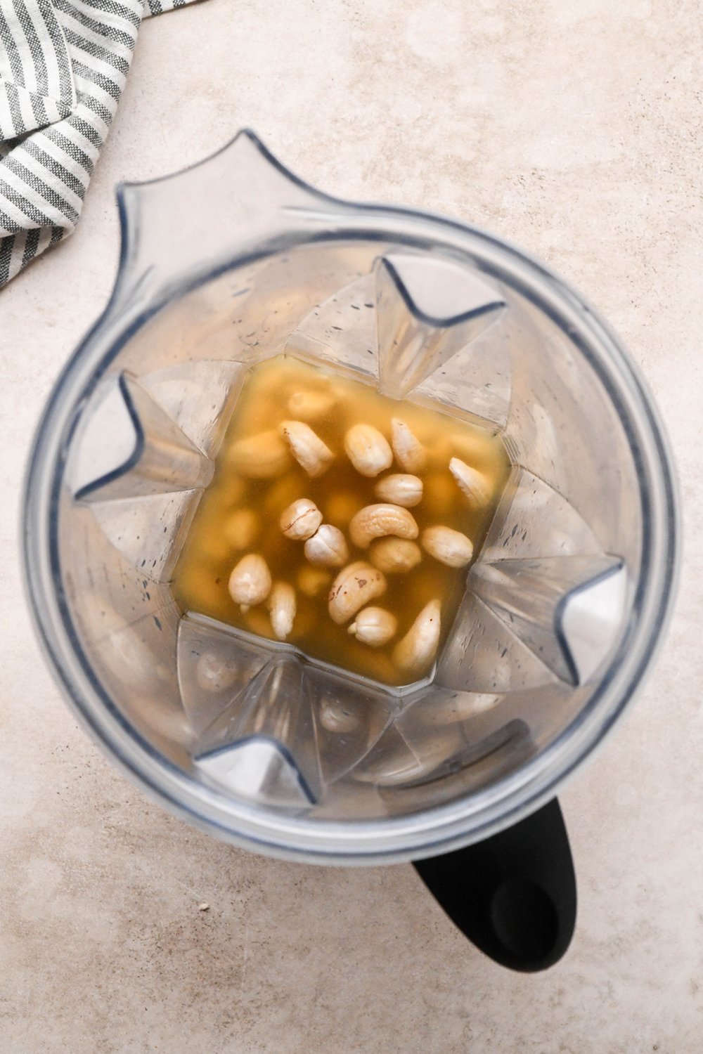 How to make Chicken and Broccoli Soup: Raw, soaked cashews in a blender container with some chicken broth - before blending.