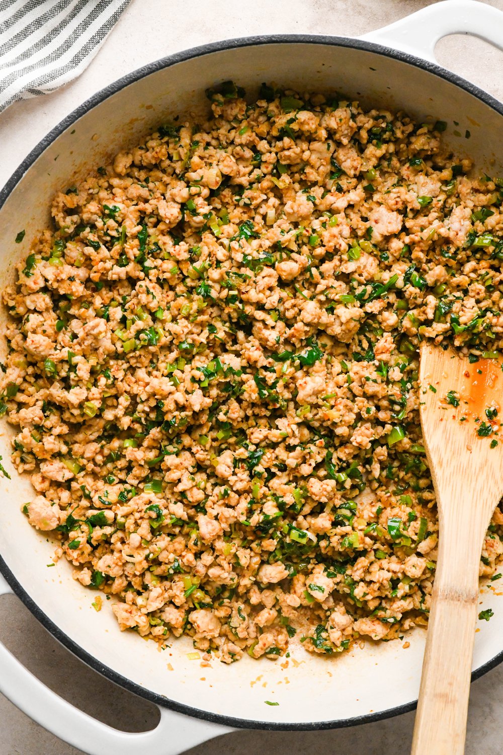 How to make garlic scallion noodles: Ground chicken mixture in the skillet after briefly sautéing to wilt the cilantro.