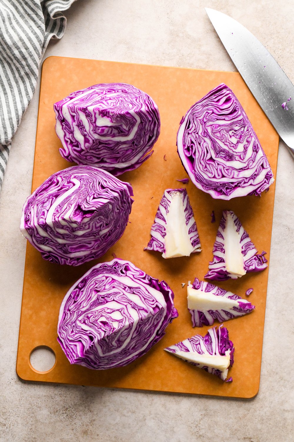 How to make Roasted Chopped Red Cabbage with Olive Oil: The stems of each quarter of cabbage have been cut away at an angle. 